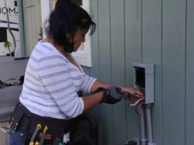 Licensed electrician wiring an exterior subpanel in Brooklyn Center