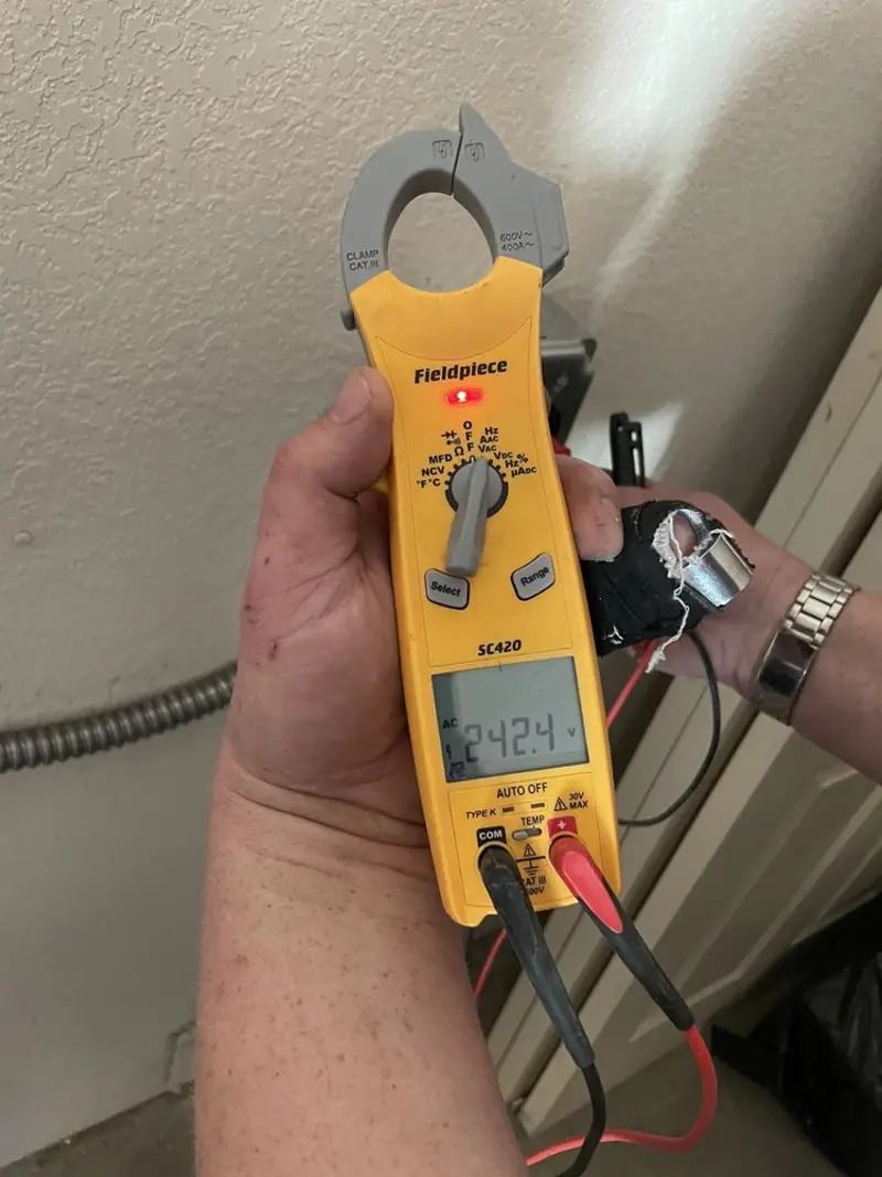 Voltage testing with clamp meter during Whole House Surge Protector in Brooklyn Center